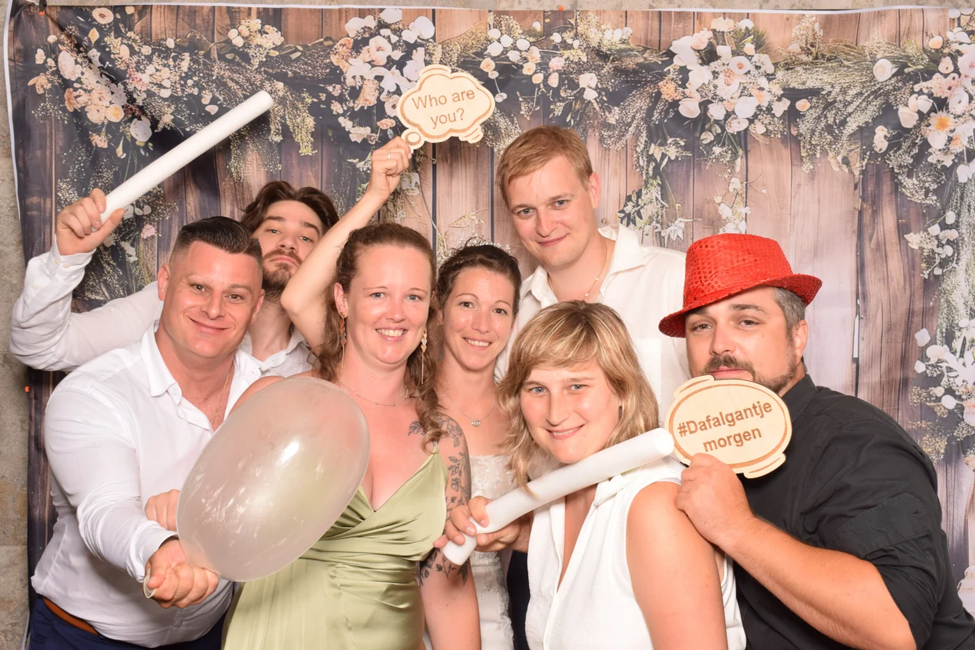 Party guests with playful props in front of the Frame This photobooth