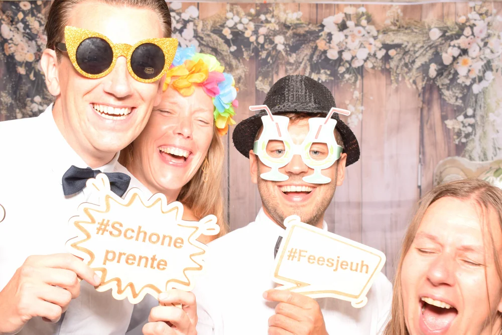 Guests posing with fun glasses and wooden props